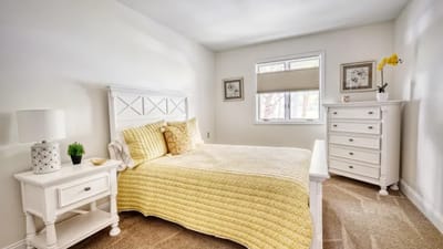 A cozy bedroom with soft yellow accents