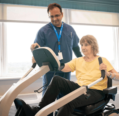 Morristown Post Acute Rehab And Nursing Center, Nursing Home in Morristown, NJ — Patient using a therapeutic exercise machine with staff assistance