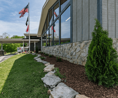 Landscape view of building exterior with flags