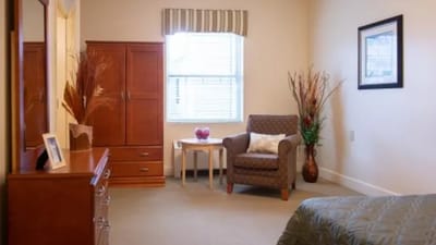 Cozy resident room with a chair and decorative plants
