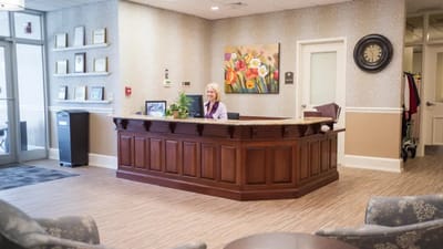 Reception area with staff member at the front desk