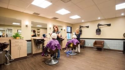Hair salon scene with residents receiving haircuts
