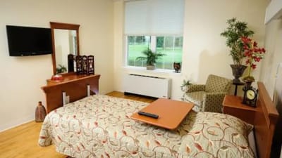 Cozy resident room with a bed and sitting area