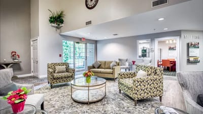 Bright lobby area with seating and floral decor