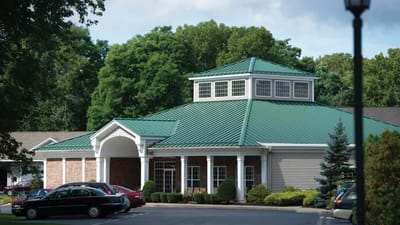 Exterior view of a senior living facility with a green roof