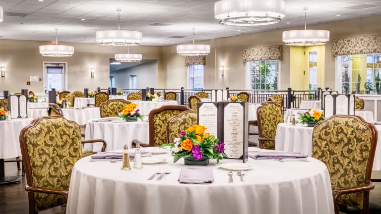 Elegant dining room setup in a senior living facility