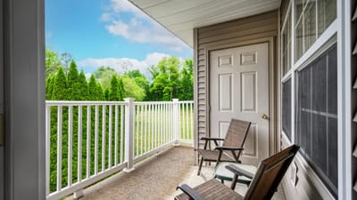 Quiet balcony with chairs overlooking greenery