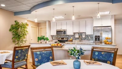 Bright dining area with modern kitchen and fruit display