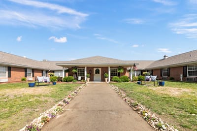 Front entrance of Oakmont Manor with landscaped path
