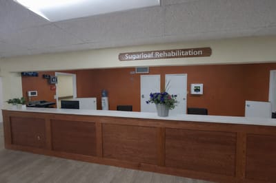 Reception area of a rehabilitation center with a wooden counter