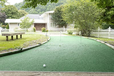 Outdoor putting green with a view of the facility
