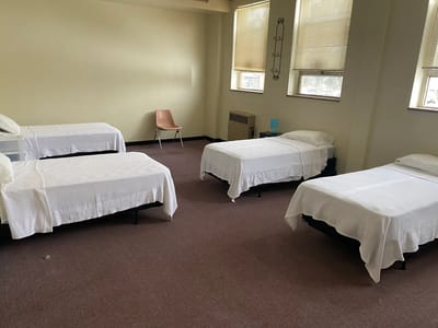 A simple, clean resident room with four beds