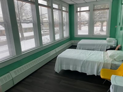 Brightly lit shared resident room with two beds