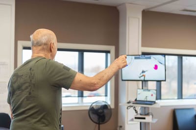 Senior resident engaging in an activity with a digital screen