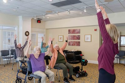 Residents participating in a seated exercise class