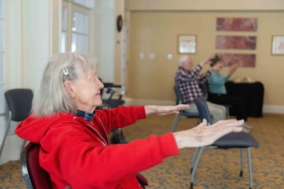 Residents participating in a seated exercise class