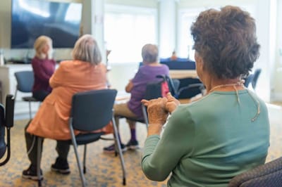 Residents attending a group activity in a common area