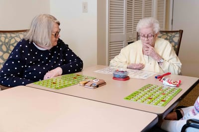 Two residents playing bingo at a table