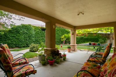 Outdoor seating area with colorful chairs and garden