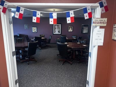 Interior view of a reserved activity room with tables and chairs