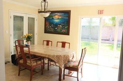 Dining area with a large table and artwork on the wall