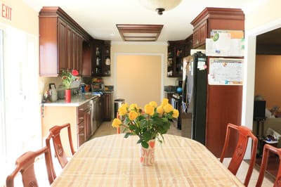 Bright common area with dining table and flowers