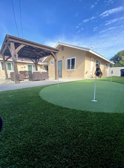 View of an outdoor putting green and patio area
