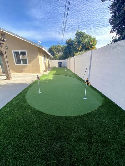 Artificial turf outdoor space with putting greens