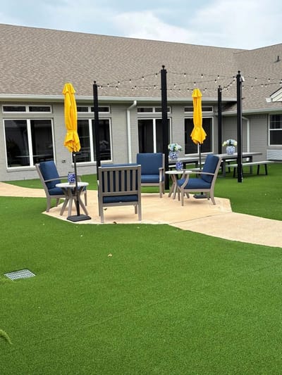 Outdoor seating area with umbrellas and green lawn