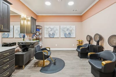 A hair salon inside the facility with styling chairs and decor