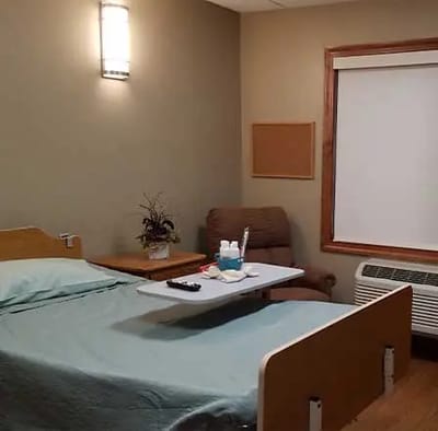 Cozy private resident room with bed and chair