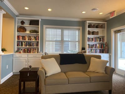 Cozy common area with a comfortable sofa and bookshelves