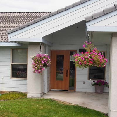 Entrance of a nursing facility with hanging flowers