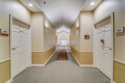 Interior hallway with resident doors in a senior living facility