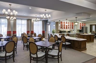 Bright dining room with tables and chairs set for meals