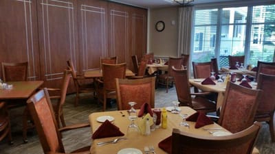 Dining area with neatly set tables and decor