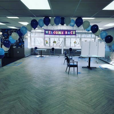Decorative welcome back event setup with balloons