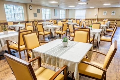 Dining area with tables and chairs in a brightly lit room