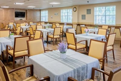 Dining room with tables and chairs set up for meals