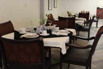 Dining area set up with table settings.