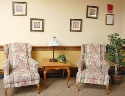 Cozy seating area with floral chairs and lamp