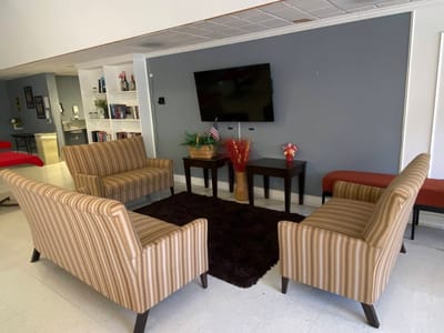 Cozy common area with seating and a television.