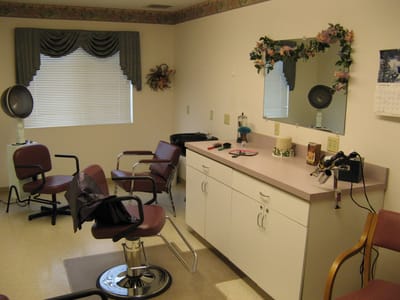 Hair salon area with styling chairs and vanity