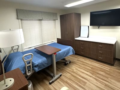 A private resident room with a bed and furnishings