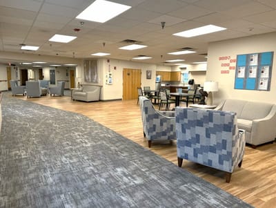Bright common area with seating and kitchen
