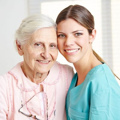 A caregiver with a resident sharing a smile