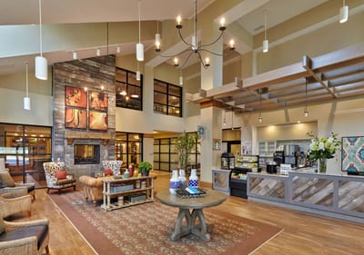 Ignite Medical Resort Dyer LLC, Nursing Home in Dyer, IN — Modern lobby with seating and decorative artwork