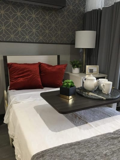 Cozy resident room with decorative pillows and table setting