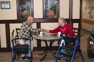 Two residents enjoying a conversation in a common area
