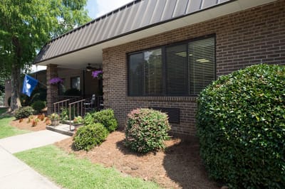 Exterior view of a senior living facility with landscaped areas